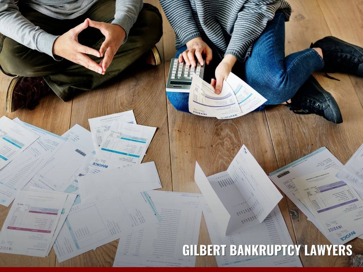 Married couple on the floor checking bills and bankrupcty alternatives